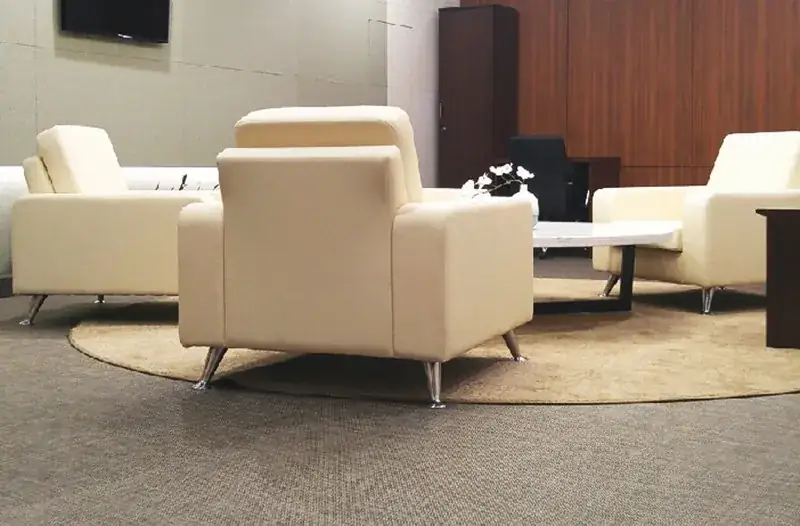 Lounge seating in a hotel in woven vinyl upholstery and wall-to-wall flooring