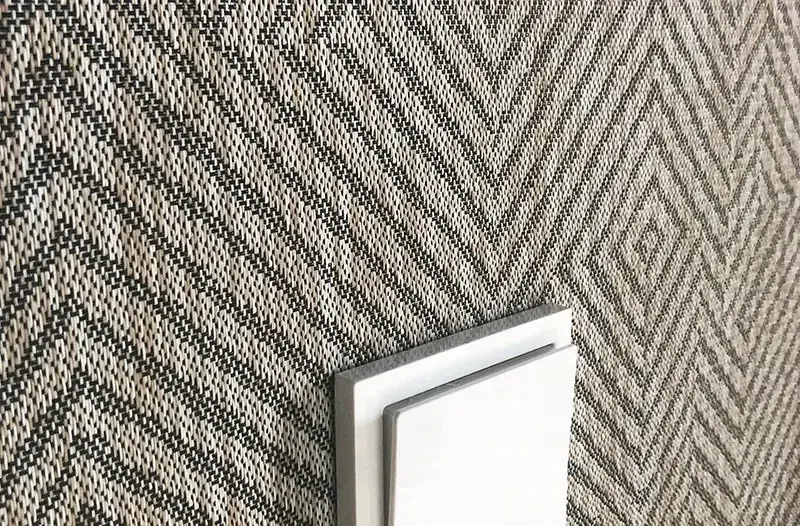 Woven vinyl wallcovering in a fine bamboo weave installed on a hotel feature wall